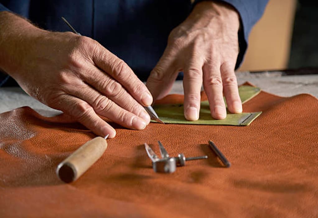 Artisan working on moccasins